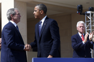 President Barack Obama shakes hands with former President George W. Bush, as former President Bill Clinton applauds at right after Obama spoke at the dedication of the George W. Bush presidential library on the campus of Southern Methodist University in Dallas, April 25, 2013.